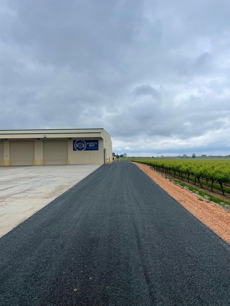 Finished sealed surface beside a commercial shed